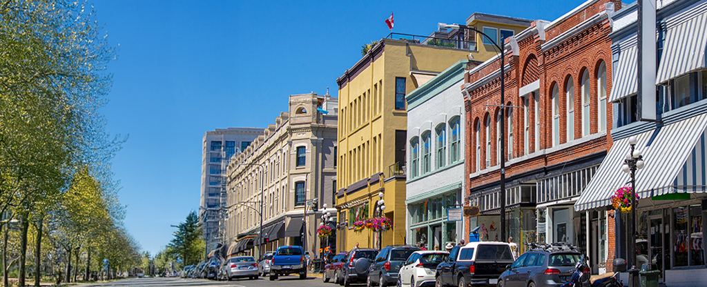 A vibrant downtown street in Canada with historic brick and colourful buildings.