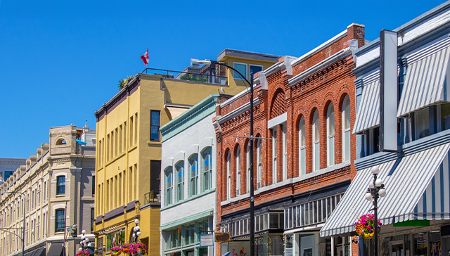 A vibrant downtown street in Canada with historic brick and colourful buildings.