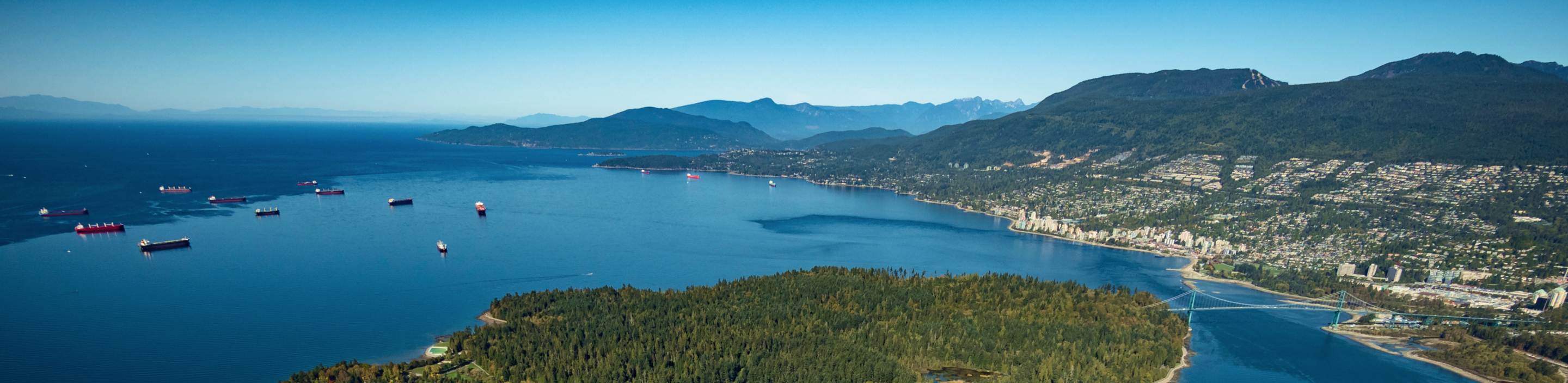 An aerial view of a mountain range and a coastal community.