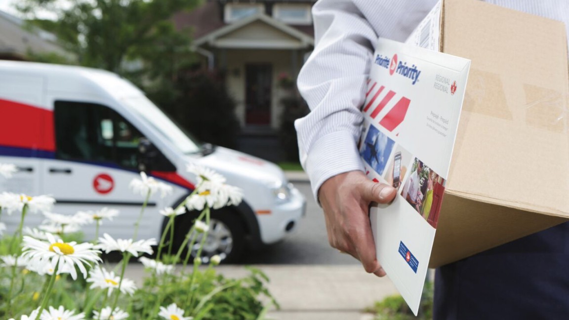 Postal worker delivering a Canada Post Priority prepaid regional shipping envelope