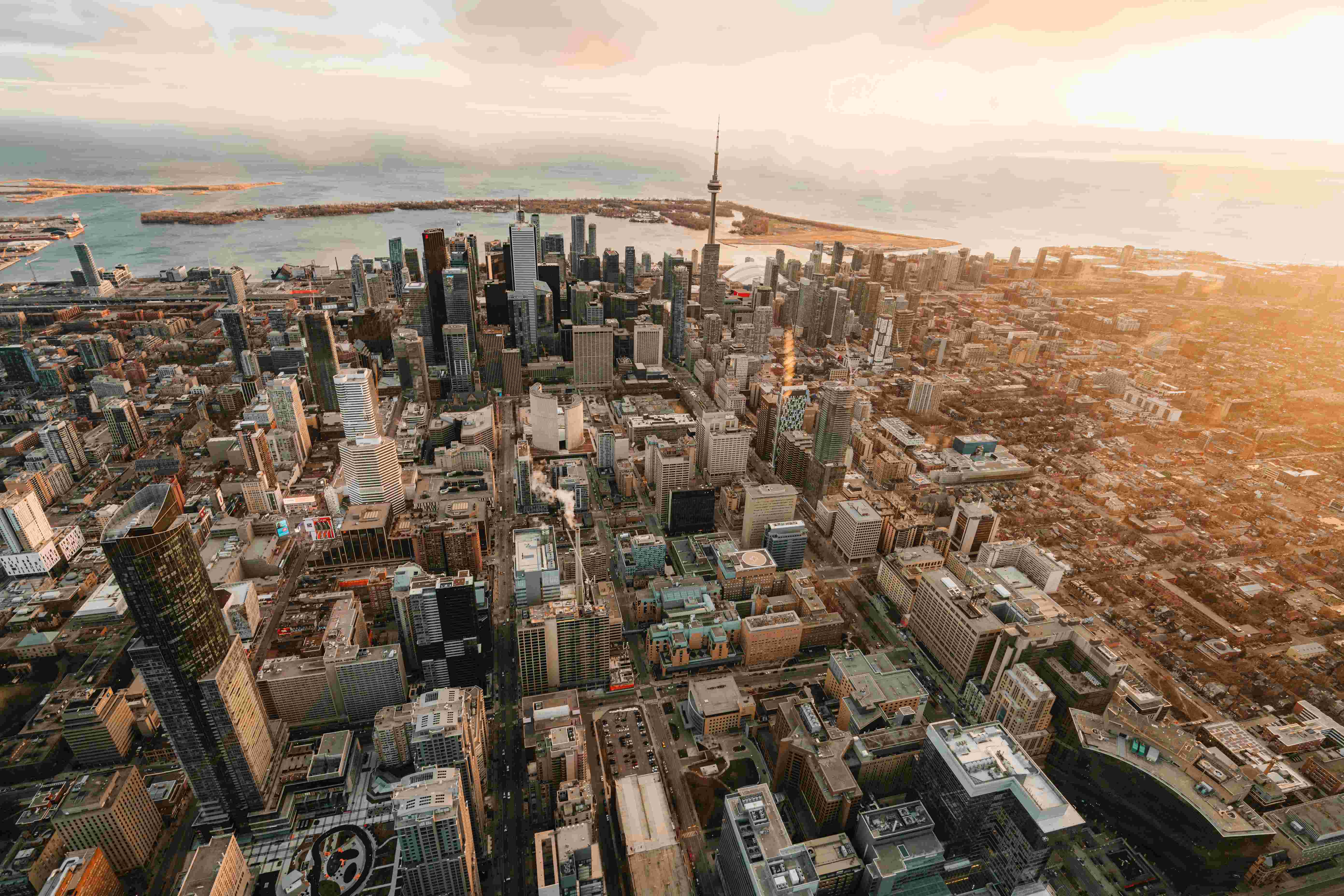 Aerial view of downtown Toronto with Lake Ontario stretching into the distance.