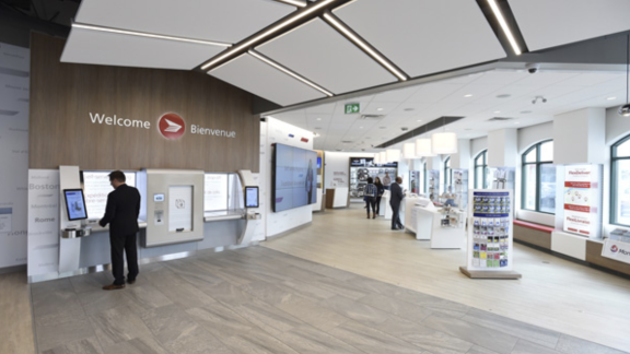 Interior view of a new post office with self-serve kiosks.