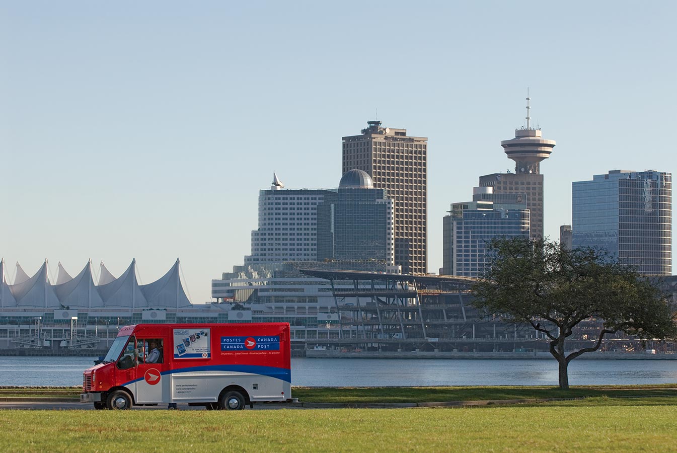 Canada Post delivery truck with downtown Vancouver in the background