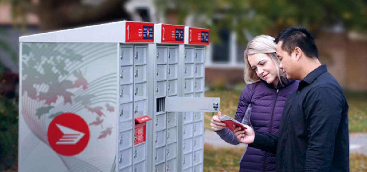 A couple retrieves their mail from a Canada Post community mailbox in a residential area.